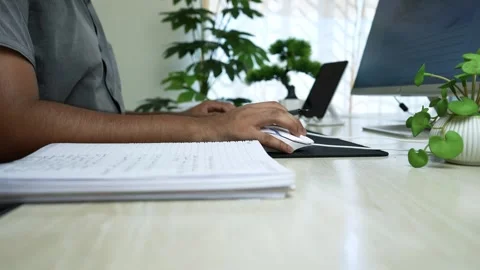 Office Workspace with Computer and Plants, Person working at a desk with a .. Stock Footage 317737140