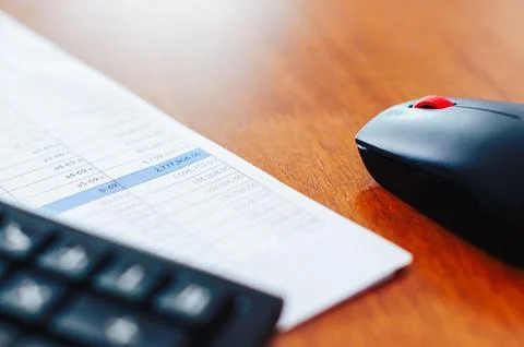 Office workspace setup mouse calculator and papers desk in minimalist envir.. 写真素材