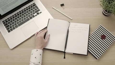 Office workspace.Drinking coffee, typing on keyboard, writing goals in notebook. Stock Footage 83416268