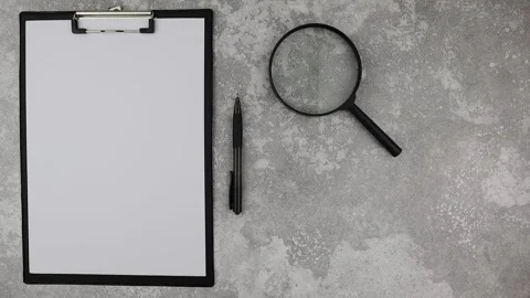Office workstation or business background with magnifying glass. Stop motion Vídeos de archivo 149074975