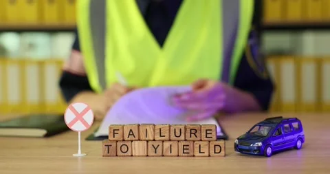 Officer explains the importance of yielding at intersections using mini cars and Stock Footage 320633711