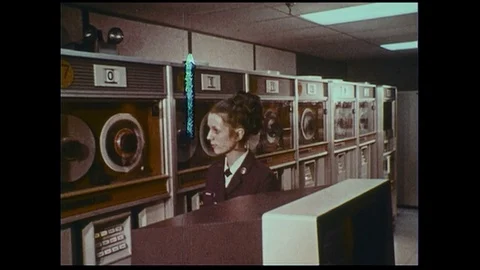 An officer observes computers as they record and store information. Stock Footage
