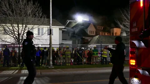 Officer speaking to man at structure fire Stock Footage 139657100