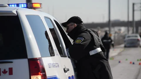 Officer Standing At Cruiser Window Stock Footage 35696959