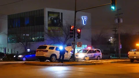 Officers analyzing clue with flashlight on car crash Stock Footage 101994147