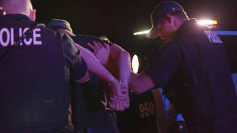 Officers Help Arrested Criminal Back to Patrol Car for Pat Down at Night Stock Footage 208722579