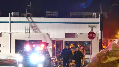 Officers looking at cameras at structure fire Stock Footage 139663800