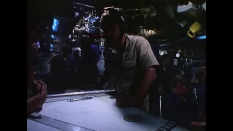 Officers plot a course on a chart and crewmen are shown aboard a United States Vídeos de archivo 118602276