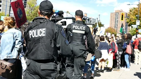 Officers walking in the crowd Stock Footage 119867383