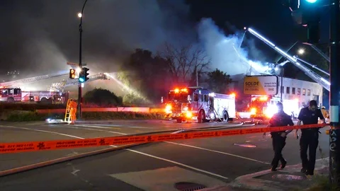 Officers walking at structure fire Stock Footage 115967510