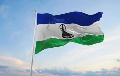 Official flag of Lesotho at cloudy sky background on sunset, panoramic view.  Stock Illustration