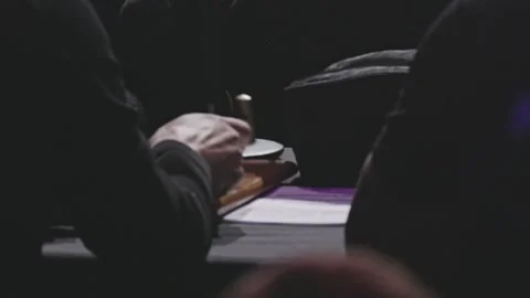 Official person stamping a document at a ceremony Stock Footage 309057932