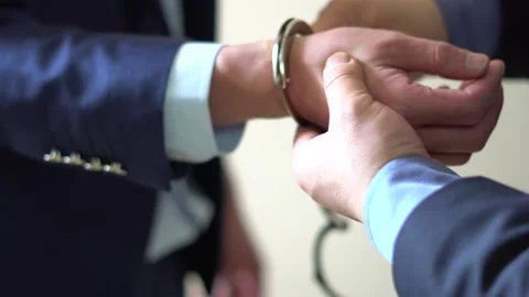 Officials arrested for corruption and bribery in handcuffs Stock Footage 154082487