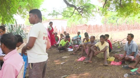 Officials processing documents with villagers in Bastar village Stock Footage 328569510