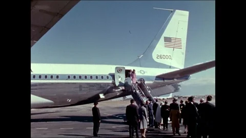Officials welcome Pres. Kennedy and his wife after they deboard the plane - 1963 Stock Footage 89352353