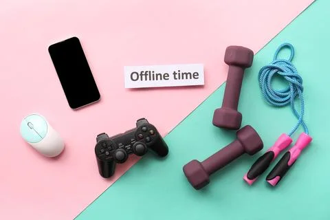 Offline time with smartphone, game controller, dumbbells, and jump rope on pi Stock Photos