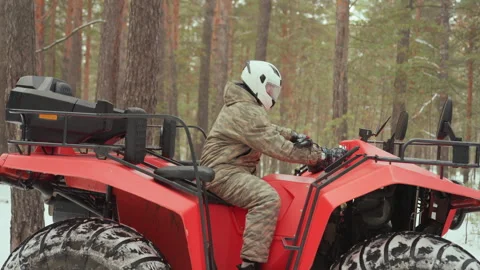 Offroad adventure readiness. Snowy forest ATV action captured. Enthusiastic ATV Video stock 345144964