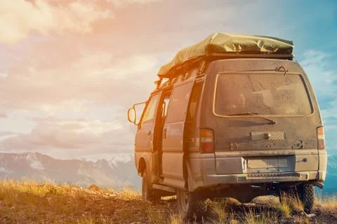 Offroad car concept with mountains. Microbus. Post-apocalyptic view Stock Photos