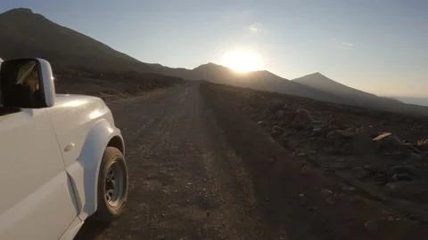 Offroad car driving at a dirt track towards the sunset Stock Footage 175698634