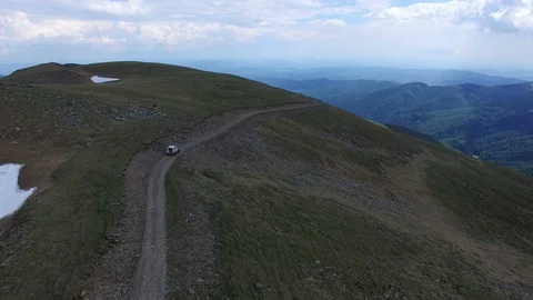 Offroad car on top of a mountain drone view Video stock 119633081