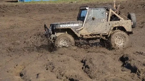 Offroad car is trying to cross the muddy area Stock Footage 71302938