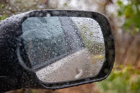 Offroad car window with side mirror in autumn bad weather Stock Photos