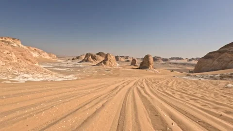 Offroad drive through white desert with sandy tracks and rocky formations. Stock Footage 339525812