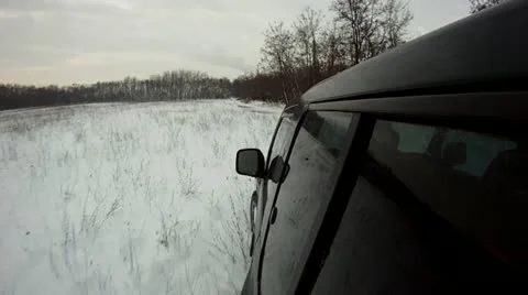 Offroad driving through snow, at sunset Stock Footage 14808416