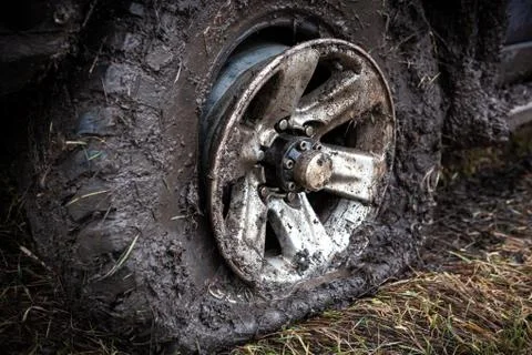 Offroad flat tyre and rim in mud close up. Stock Photos