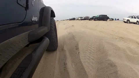 Offroad tires on sandy beach Stock Footage 23765156
