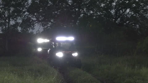 Offroad Utility Vehicles with Bright Headlights in the Rain Stock Footage 323404753