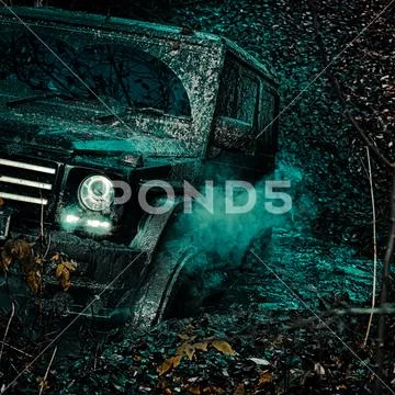 Offroad vehicle coming out of a mud hole hazard. Road adventure. Adventure Stock Photos