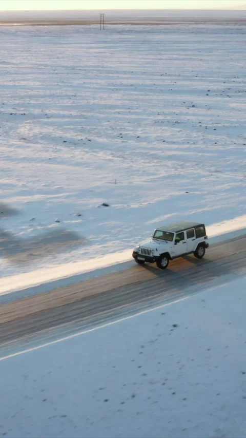Offroad vehicle driving on road through Nordic winter landscape. Big logo of Stock Footage 323730167