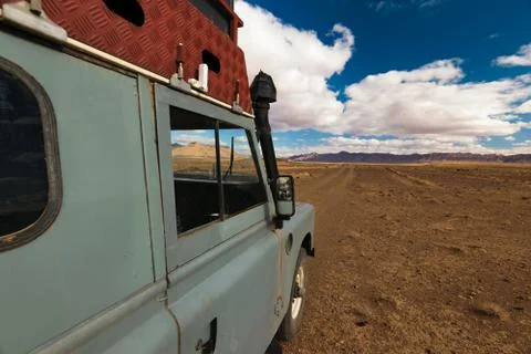 Offroad vehicle oldtimer driving off road in Morocco Stock Photos