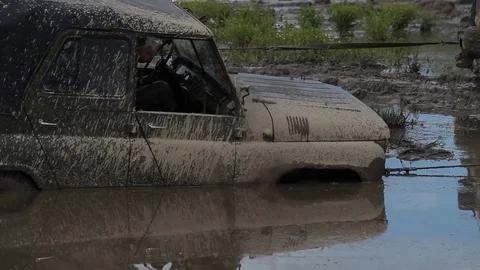 Offroad vehicle stuck in the mud Stock Footage 71581548