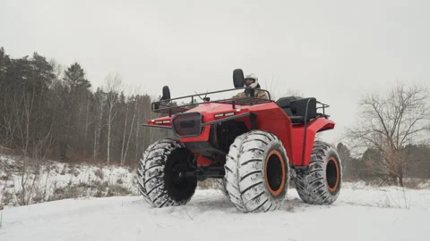 Offroad vehicle testing in winter. Snowed field with ATV and rider testing Stock Footage 332047178