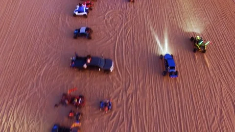 Offroad vehicles line up to watch the drag race in the desert Stock Footage 99158568