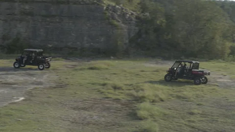 Offroad vehicles racing by cliffs Stock Footage 323403548