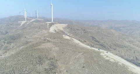 Offroad Vehicles Run between Wind Turbines Stock-Footage 107439589