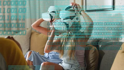 Offscreen handing headsets two women inspecting donning VR units on couch Stock Footage 333671156