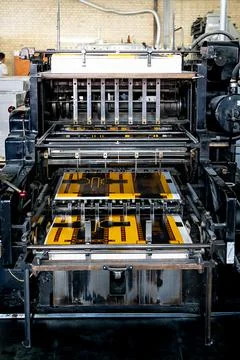 Offset printing machine feeder transfer metallic paper through the feeding ta Stock Photos
