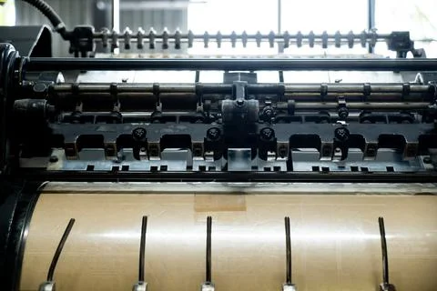 Offset printing machine feeder transfer metallic paper through the feeding ta Stock Photos