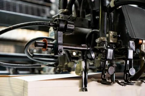 Offset printing machine feeder transfer metallic paper through the feeding ta Stock Photos