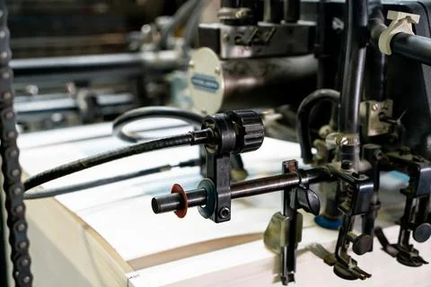 Offset printing machine feeder transfer metallic paper through the feeding ta Stock Photos