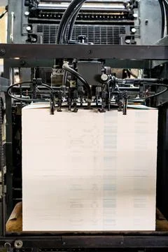 Offset printing machine feeder transfer metallic paper through the feeding ta Stock Photos