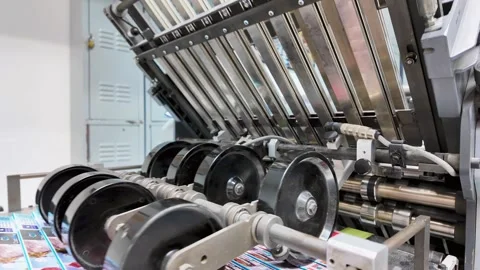 Offset Printing Process. Close up Folding machine. Detail with print products Stock Footage 310314448