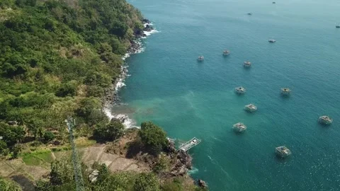 Offshore Aquaculture Floating Platforms and Rocky Coastline in Ciletuh 動画素材 344624964