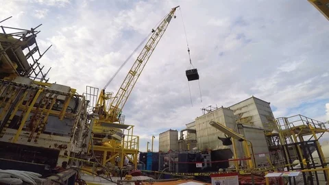 Offshore crane lifting busket in less space on platform Stock Footage 113863842