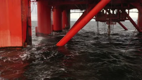 Offshore drilling platform supports. Side view of moonpool rig. Red legs. Waves 스톡 동영상 165107800