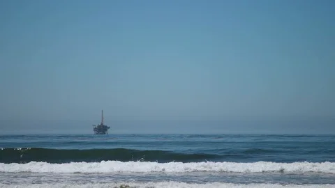 Offshore Drilling Rig in the Distance from Beach | 4K slow motion footage Stock Footage 114392759